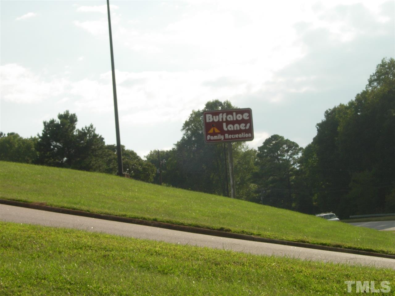6521 Fayetteville Road Raleigh, NC 27603 - Photo 3 of 3 a view of a field of grass with a small yard