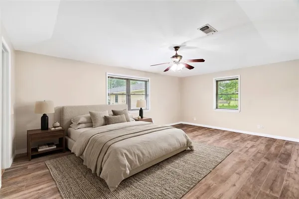 a bedroom with a large bed and a window