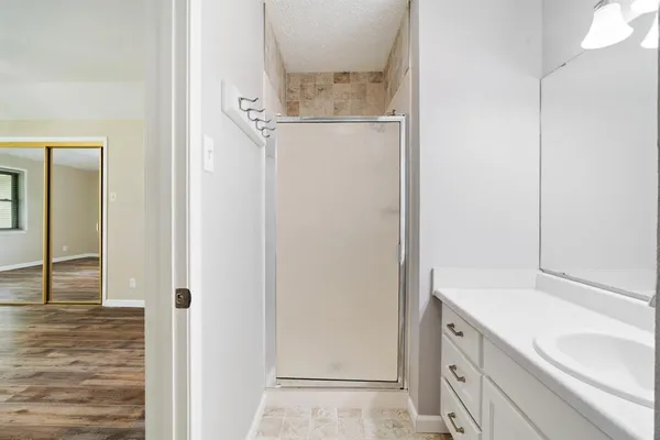 a bathroom with a granite countertop sink and a mirror
