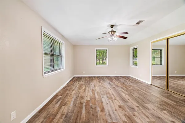 wooden floor in an empty room with a window
