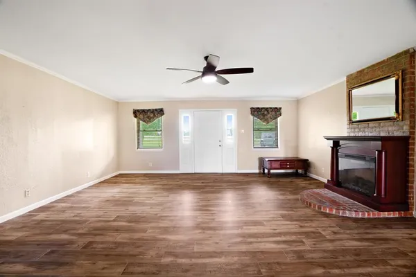 a view of an empty room with window and fireplace