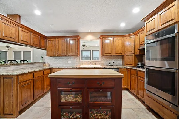 a kitchen with stainless steel appliances granite countertop a stove sink and microwave