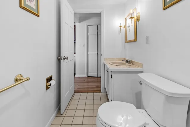 a white toilet sitting next to a bathroom sink