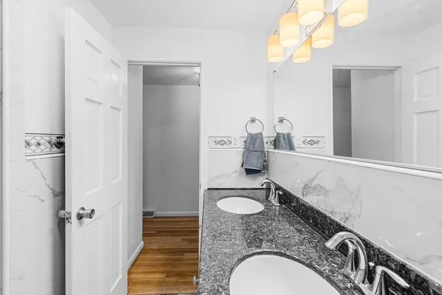 a bathroom with mirror sink and vanity