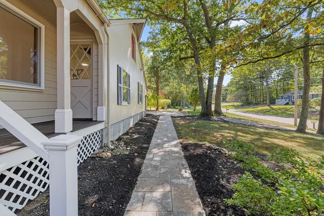 a view of a pathway of a house with a yard