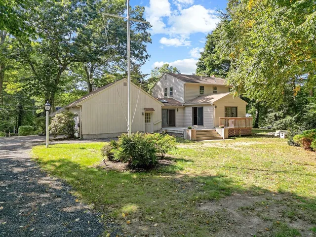 a view of a house with pool and a yard