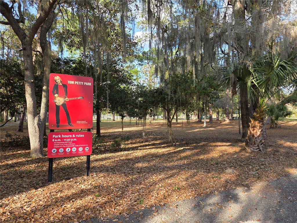 3 Northeast 13th Street Gainesville, FL 32601 - Photo 3 of 4 a street sign under a large tree