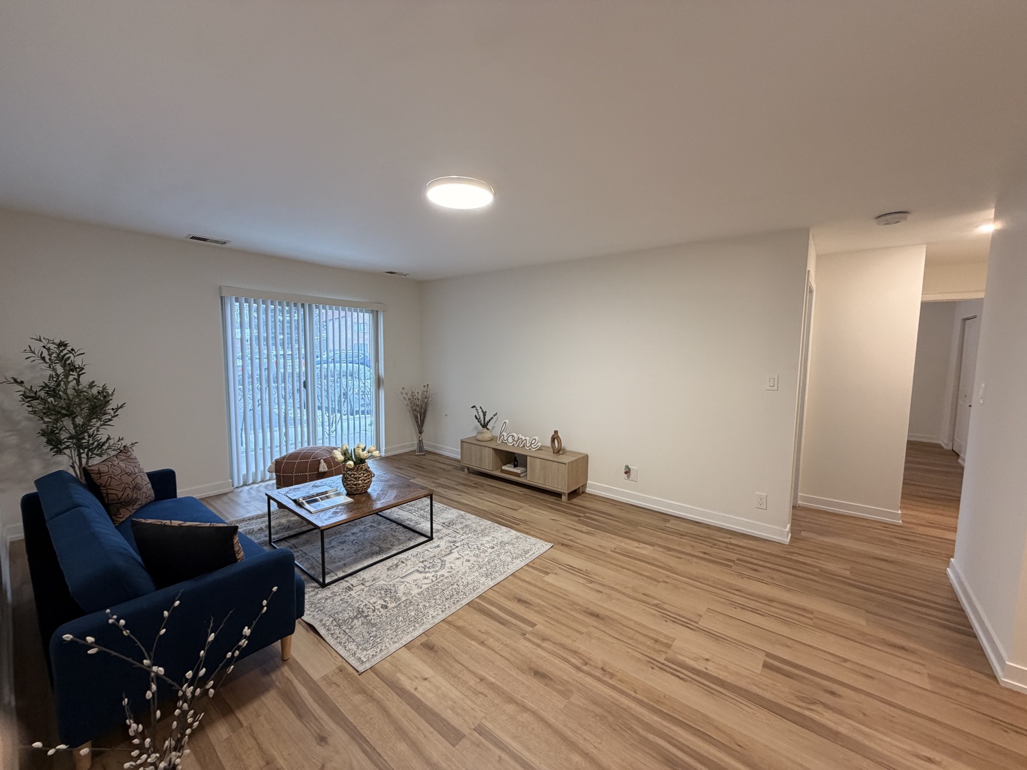 607 West Central Road, Unit A4 Mount Prospect, IL 60056 - Photo 2 of 13 a living room with furniture and wooden floor