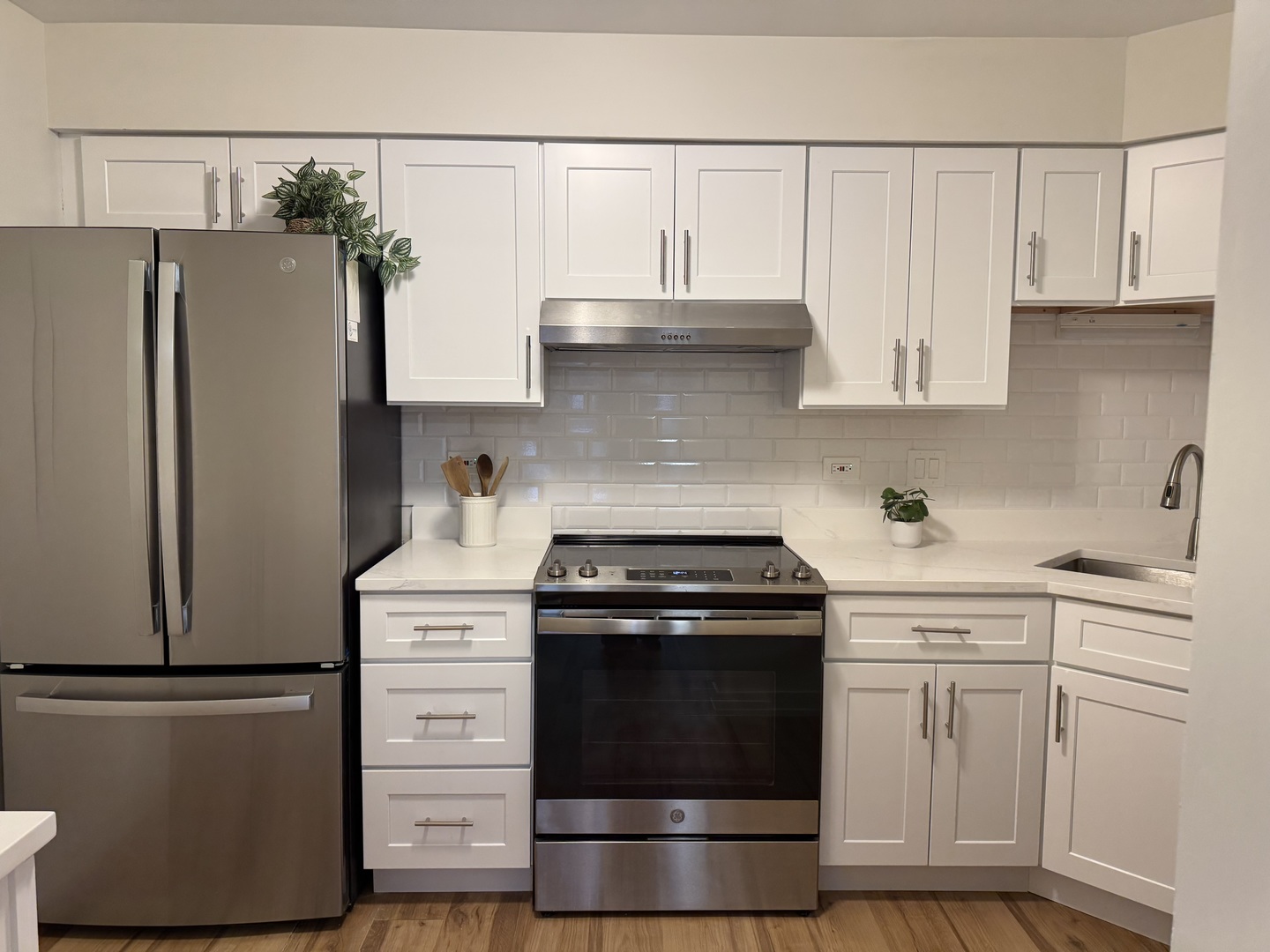 607 West Central Road, Unit A4 Mount Prospect, IL 60056 - Photo 5 of 13 a kitchen with white cabinets and white appliances