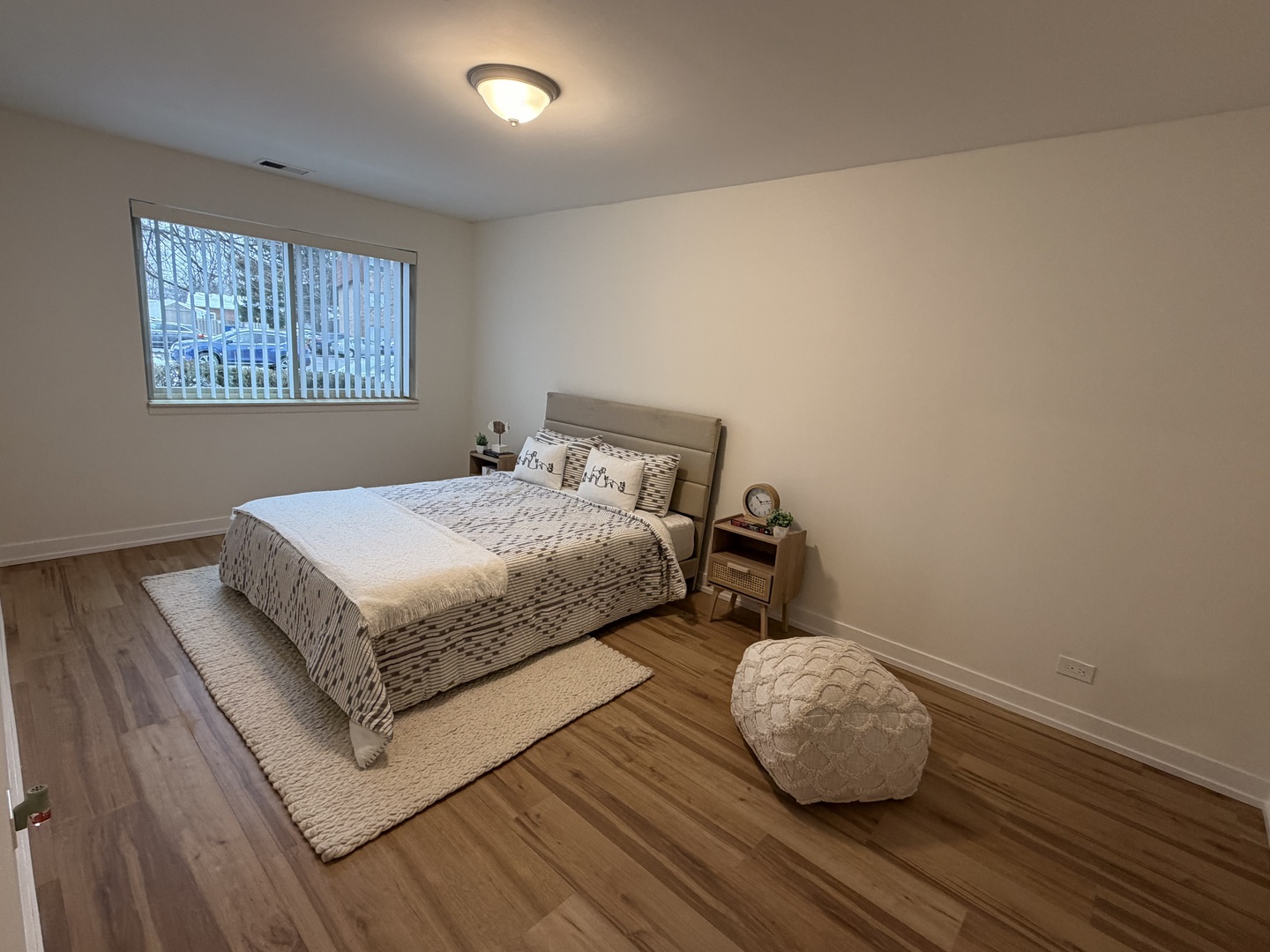 607 West Central Road, Unit A4 Mount Prospect, IL 60056 - Photo 7 of 13 a bedroom with a bed and wooden floor