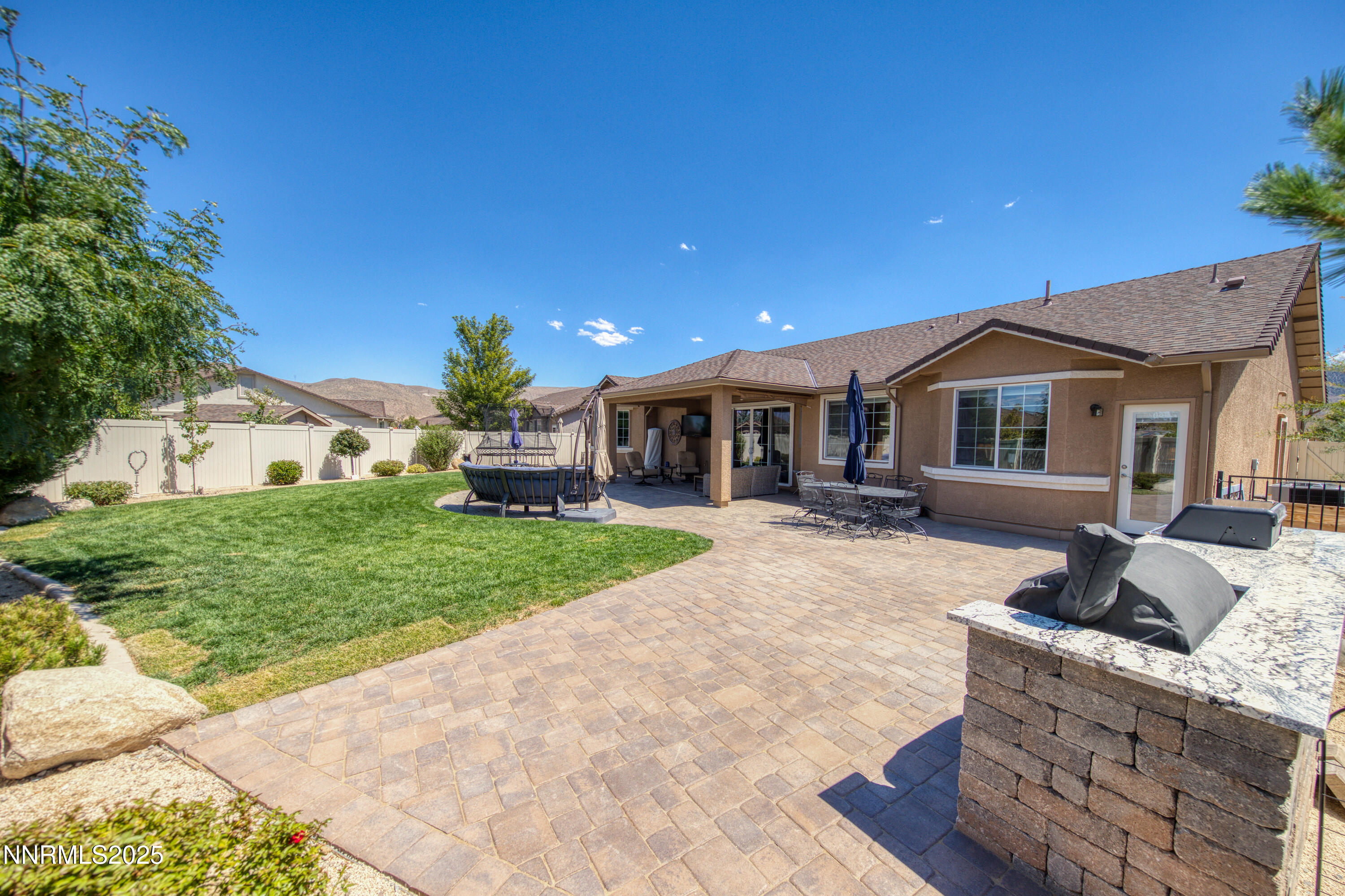 2225 Renzo Way Reno, NV 89521 - Photo 45 of 60 a front view of a house with a garden and patio