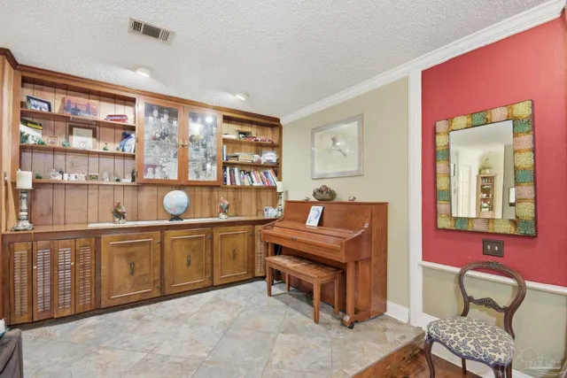 a living room with furniture and painting on the wall