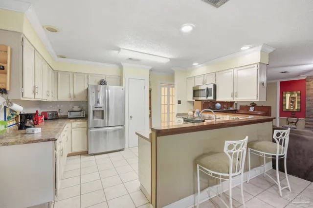 a kitchen with sink cabinets and stove
