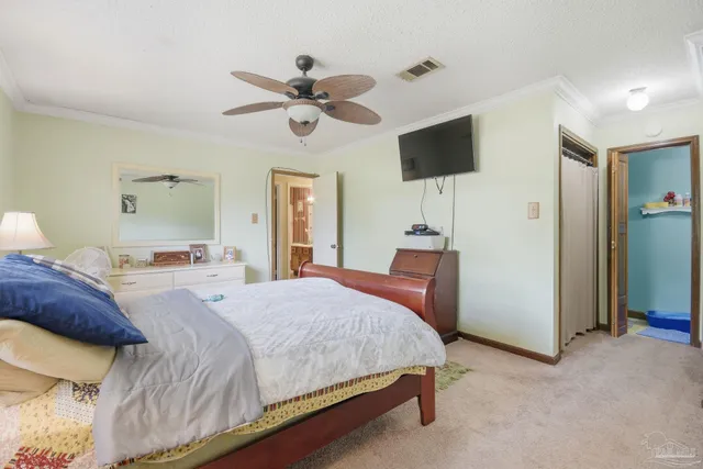 a bedroom with a bed and a lamp