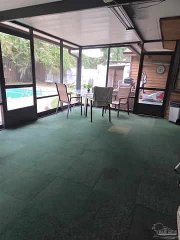a room with pool table and a floor to ceiling window