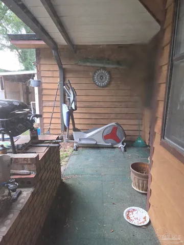 a view of a kitchen with wooden floor and a rug