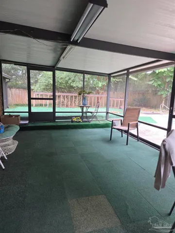a view of an empty room with a rug