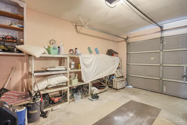 a kitchen with a sink white cabinets and white appliances