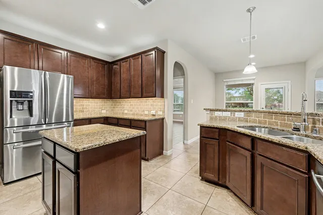 a kitchen with a sink stove and refrigerator