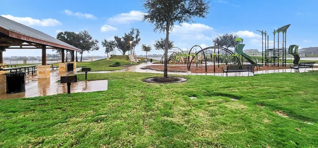 a swimming pool with outdoor seating and garden