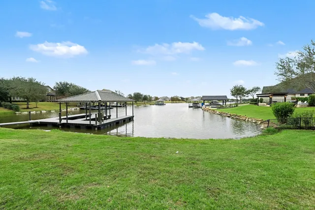 a view of a lake with houses in the back