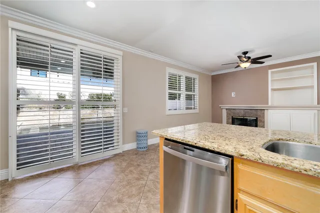 a kitchen with a granite countertop sink and white cabinets