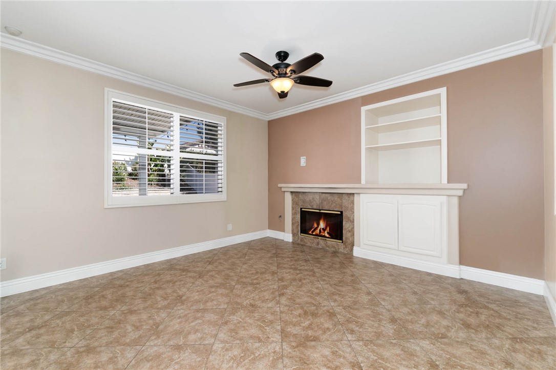 12206 Tunbridge Court Rancho Cucamonga, CA 91739 - Photo 18 of 34 a view of an empty room with a fireplace and a window