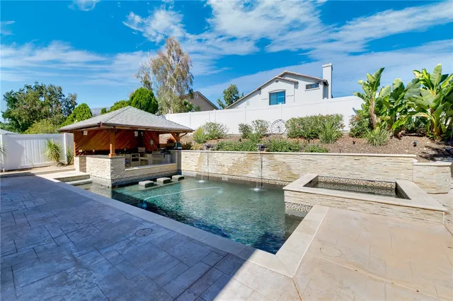 a view of a patio with swimming pool table and chairs