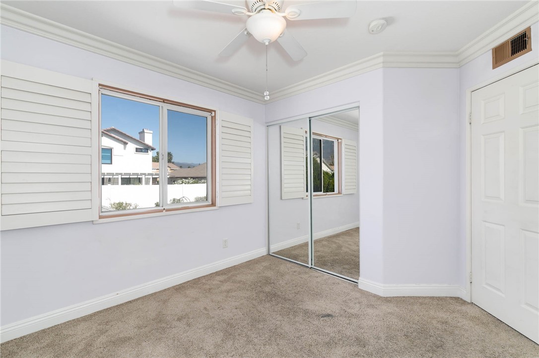 12206 Tunbridge Court Rancho Cucamonga, CA 91739 - Photo 7 of 34 a view of an empty room with window and chandelier fan