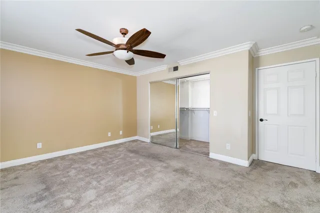 a view of an empty room with a ceiling fan