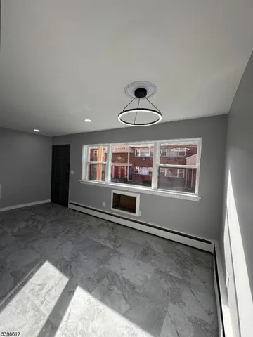 a view of a livingroom with a ceiling fan and window