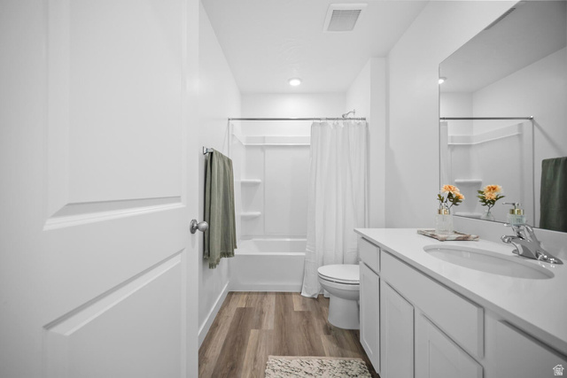 2123 Wolverine Way, Unit 2437 Washington, UT 84780 - Photo 26 of 40 Bathroom featuring a single vanity with a white countertop and undermount sink, wood-finish flooring, and a white tub with shower