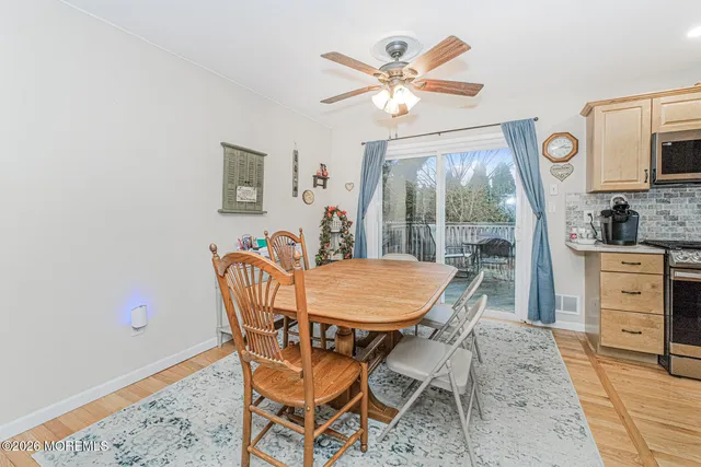 a dining room with furniture a flat screen tv and a window