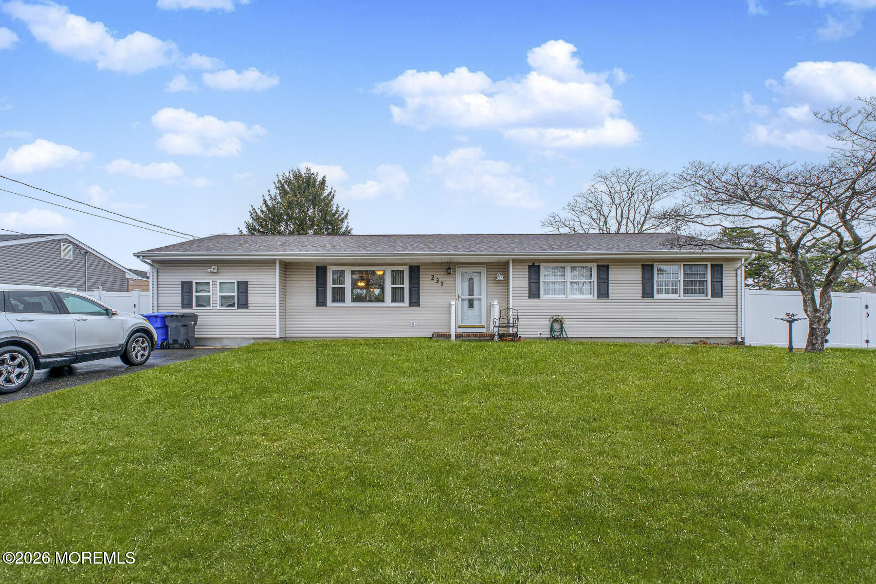 237 Pine Tree Drive Brick, NJ 08723 - Photo 14 of 24 a view of a house with a big yard and large trees