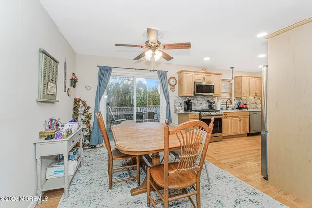 a dining room with a wooden table and chairs