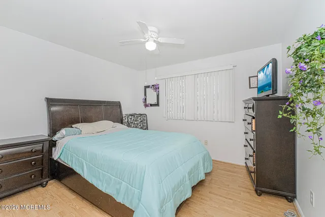 a bedroom with a bed and a potted plant