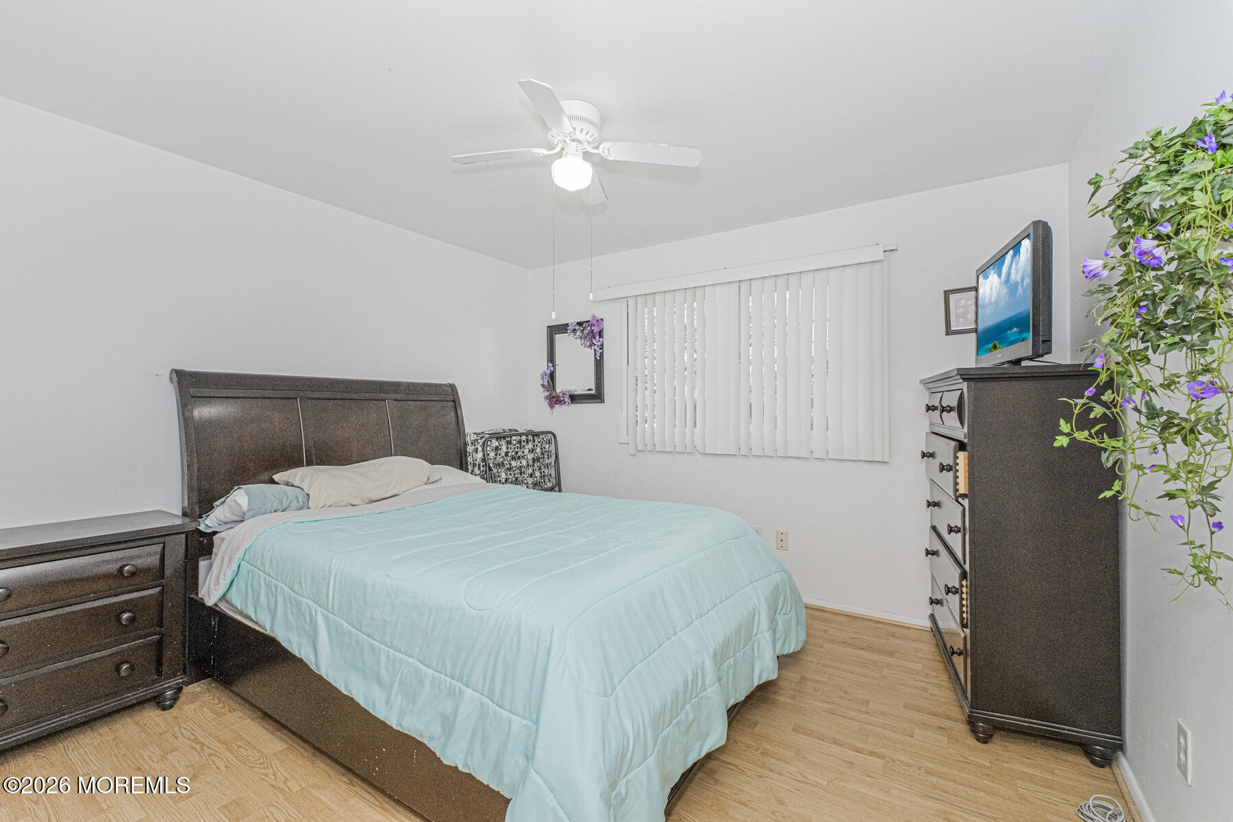 237 Pine Tree Drive Brick, NJ 08723 - Photo 17 of 24 a bedroom with a bed and a potted plant