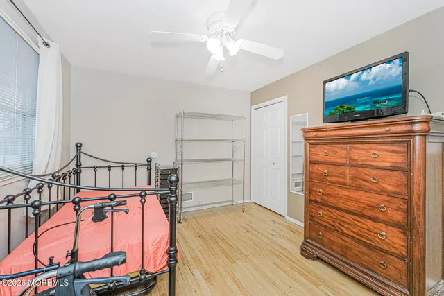 a view of a livingroom with wooden floor and a ceiling fan