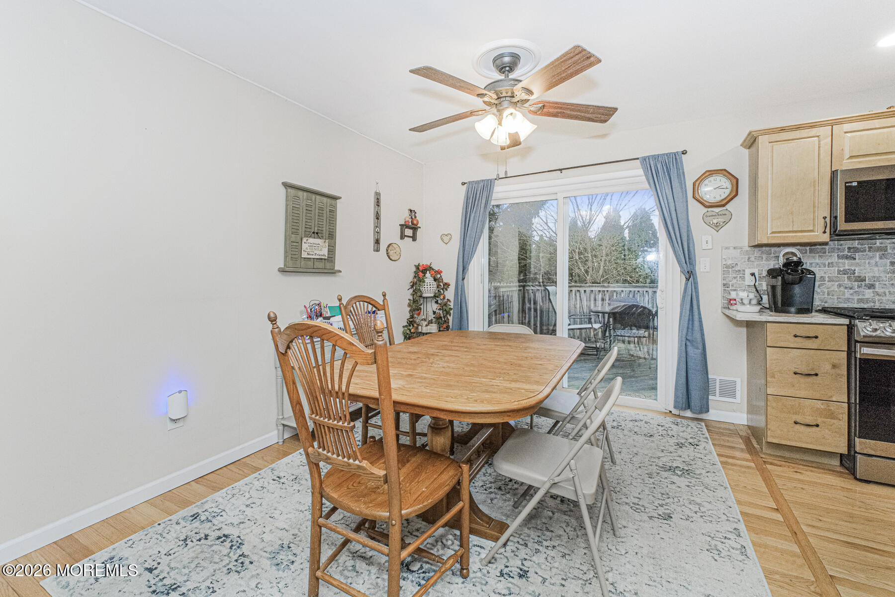 237 Pine Tree Drive Brick, NJ 08723 - Photo 20 of 24 a dining room with furniture a flat screen tv and a window
