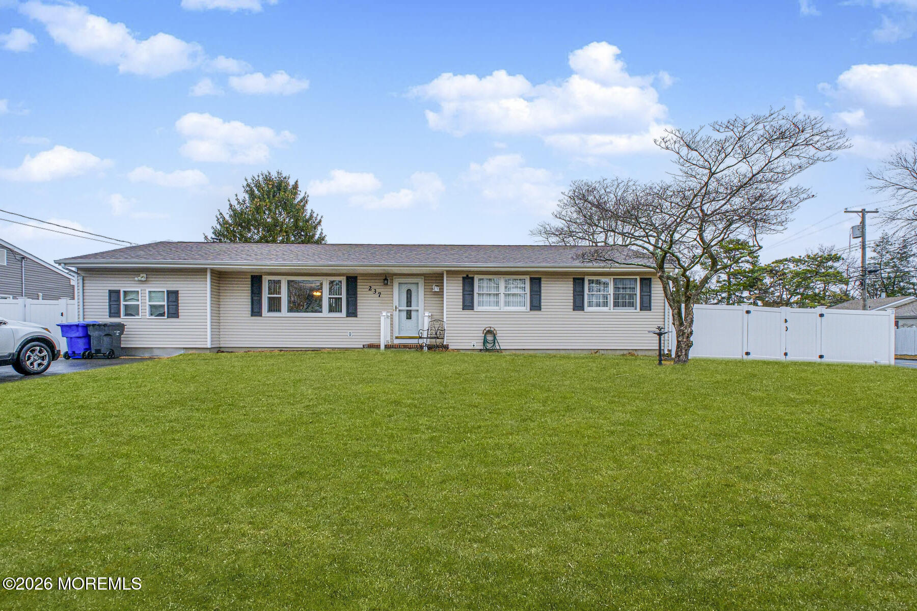 237 Pine Tree Drive Brick, NJ 08723 - Photo 2 of 24 a view of a yard in front of a house with large trees