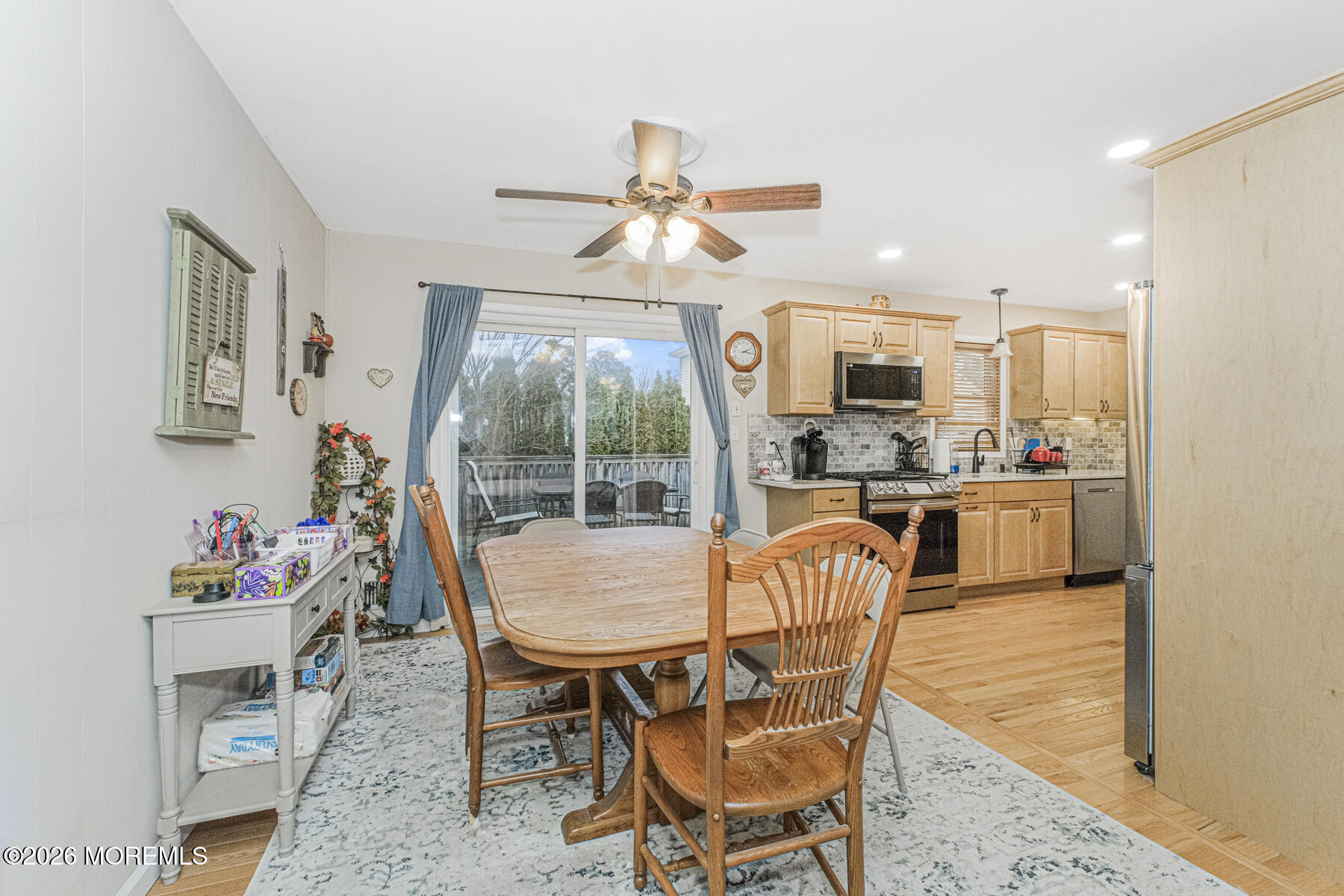 237 Pine Tree Drive Brick, NJ 08723 - Photo 21 of 24 a dining room with a wooden table and chairs