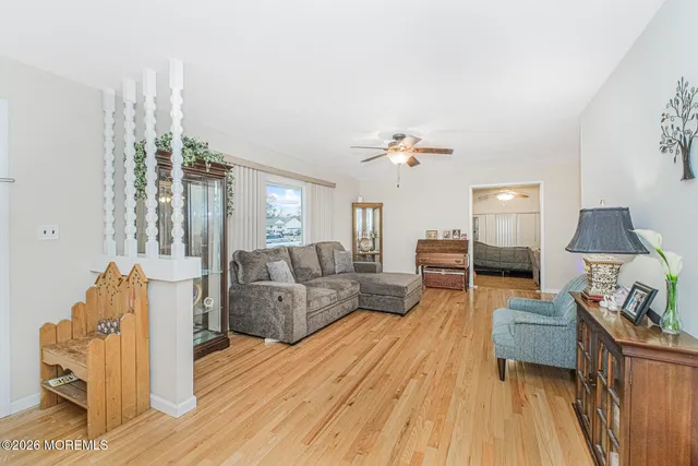 a living room with furniture and a wooden floor