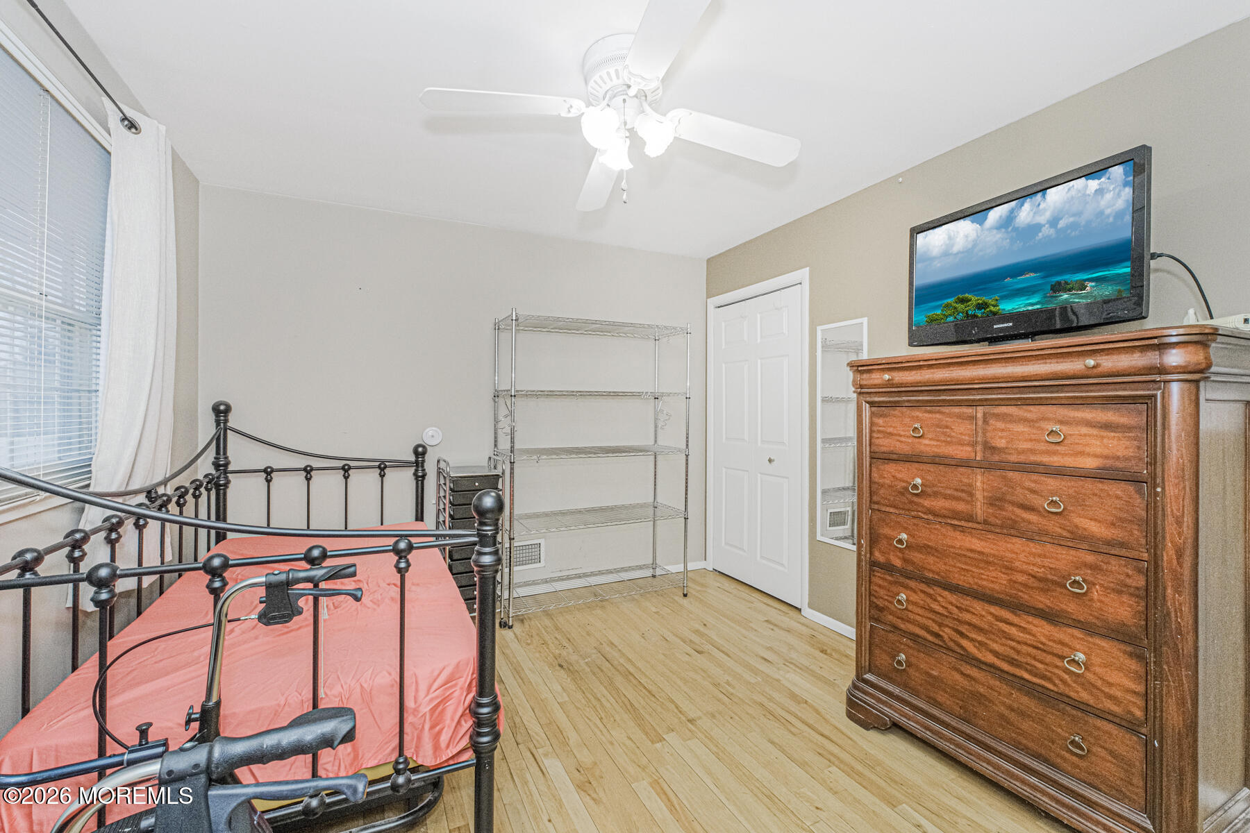 237 Pine Tree Drive Brick, NJ 08723 - Photo 8 of 24 a view of a livingroom with wooden floor and a ceiling fan