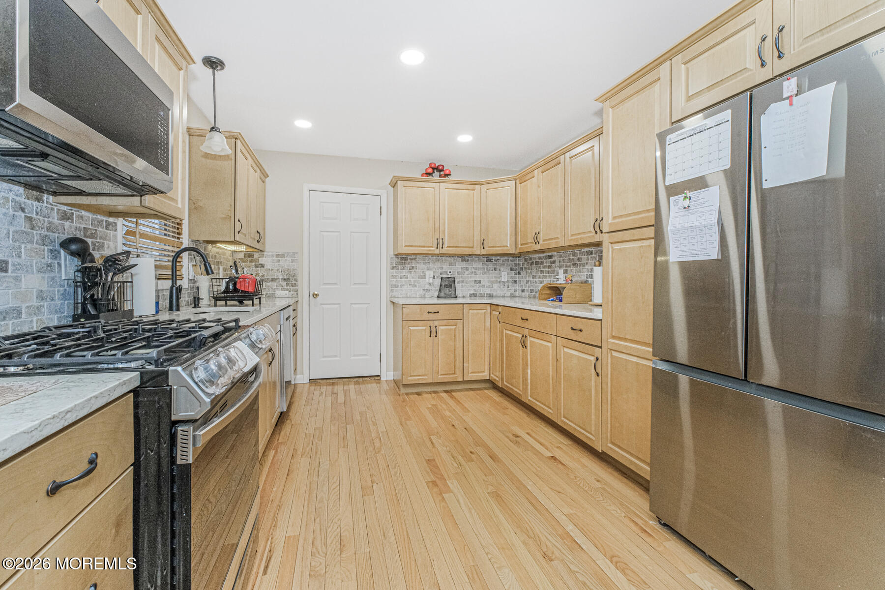 237 Pine Tree Drive Brick, NJ 08723 - Photo 10 of 24 a kitchen with stainless steel appliances granite countertop a stove and a refrigerator