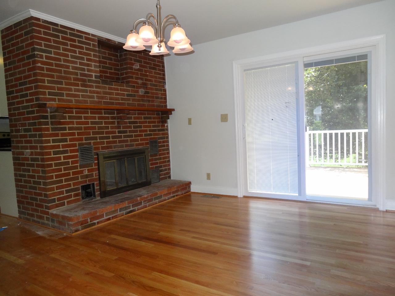12895 Hardy Road Hardy, VA 24101 - Photo 6 of 15 a view of a livingroom with wooden floor a fireplace and a window