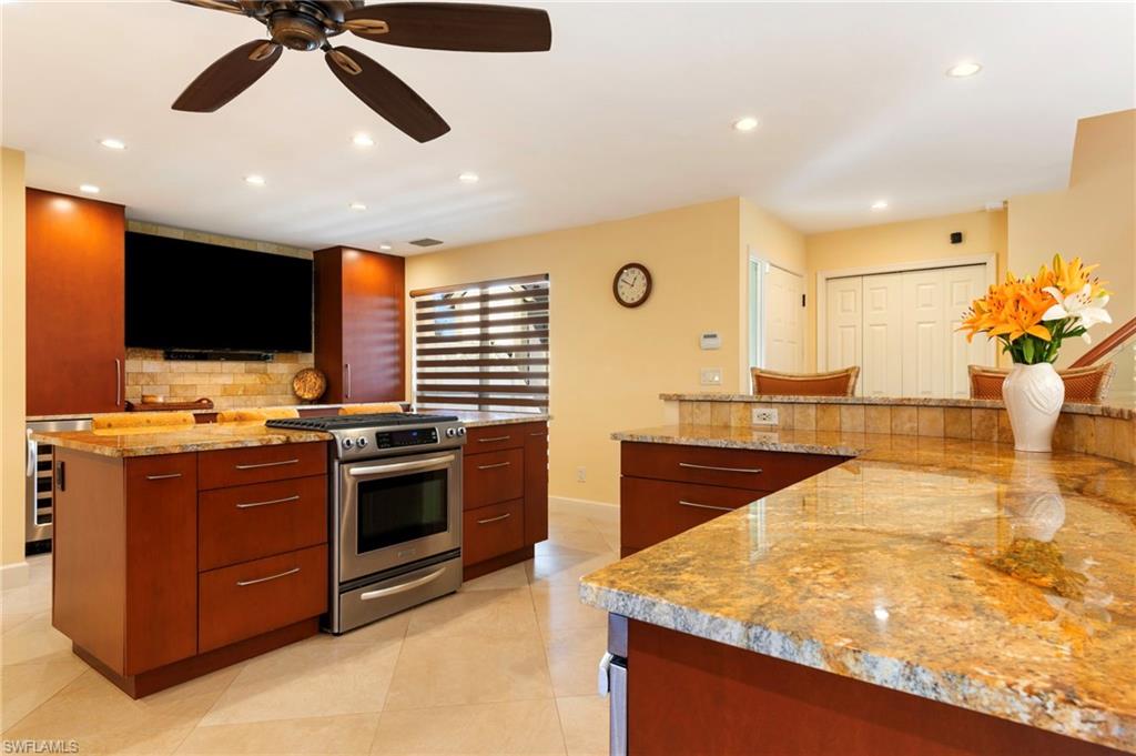 11737 Quail Village Way Naples, FL 34119 - Photo 11 of 50 a kitchen with stainless steel appliances granite countertop a stove and a sink