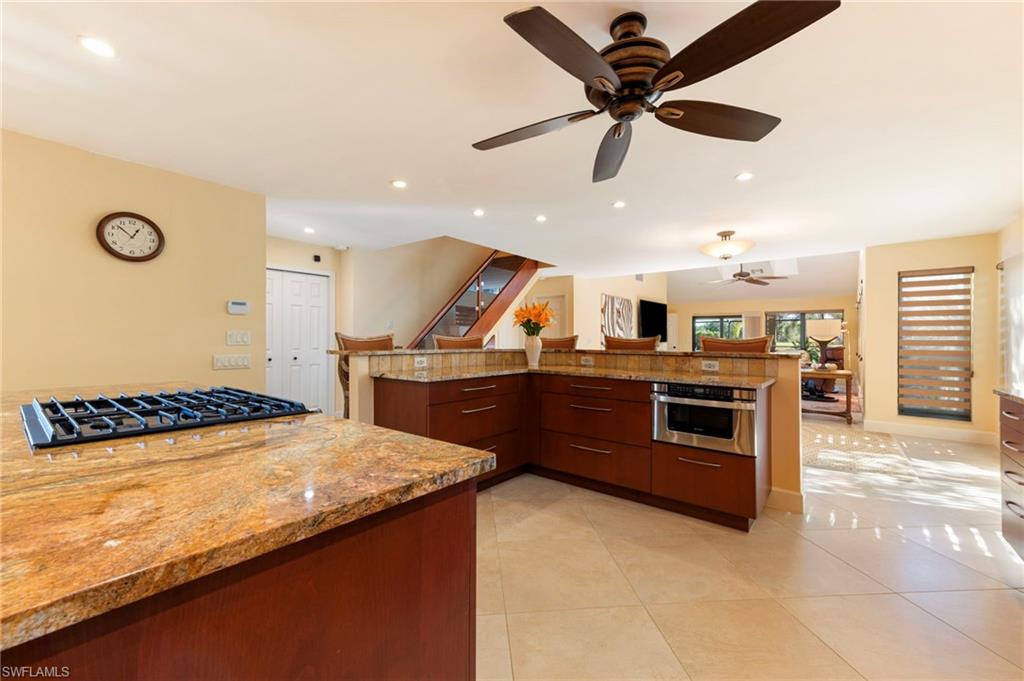 11737 Quail Village Way Naples, FL 34119 - Photo 50 of 50 a kitchen with stainless steel appliances granite countertop a stove and a sink
