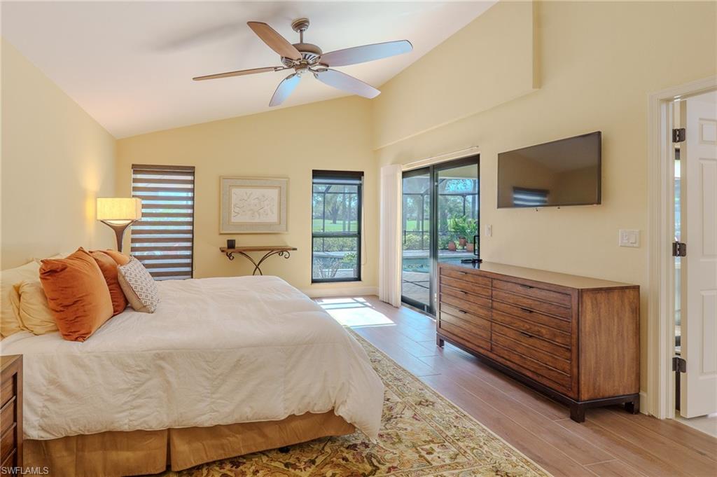 11737 Quail Village Way Naples, FL 34119 - Photo 17 of 50 a bedroom with a bed and a flat screen tv