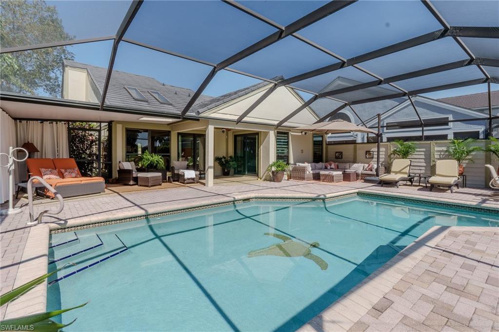 11737 Quail Village Way Naples, FL 34119 - Photo 2 of 50 a view of a patio with a table and chairs