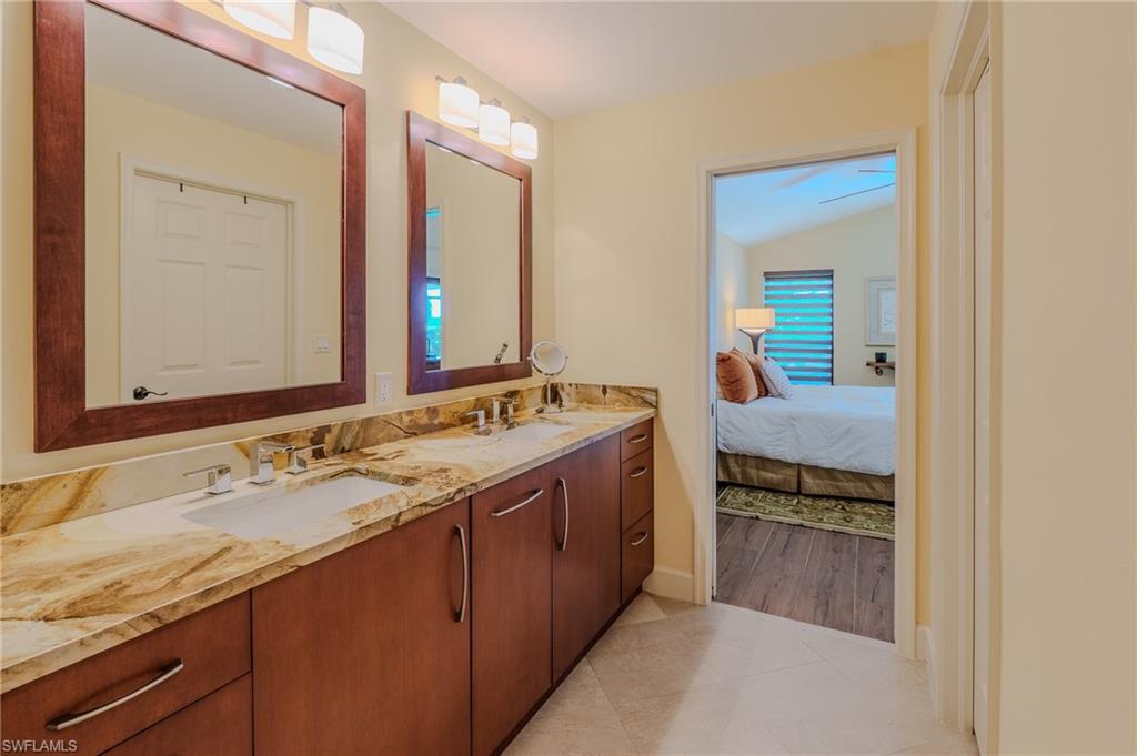 11737 Quail Village Way Naples, FL 34119 - Photo 21 of 50 a bathroom with a granite countertop double vanity sink and a mirror